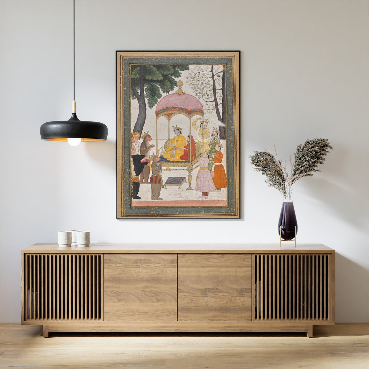 Framed art print of Enthroned Rama and Sita Receive Homage from their Monkey and Bear Allies by Pahari school, above a slatted wood sideboard