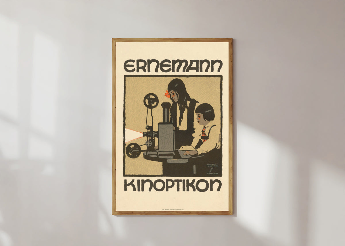 Framed art print of Ernemann Kinoptikon by Ludwig Hohlwein, in a light wood frame on a sunlit white wall