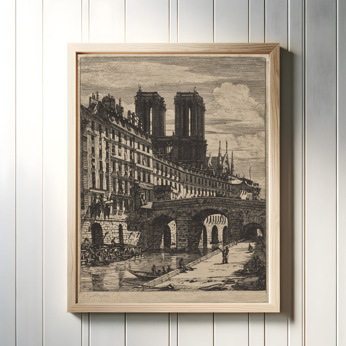 Framed art print of Etchings of Paris: The Little Bridge by Charles Meryon, in a light wood frame on a white panelled wall