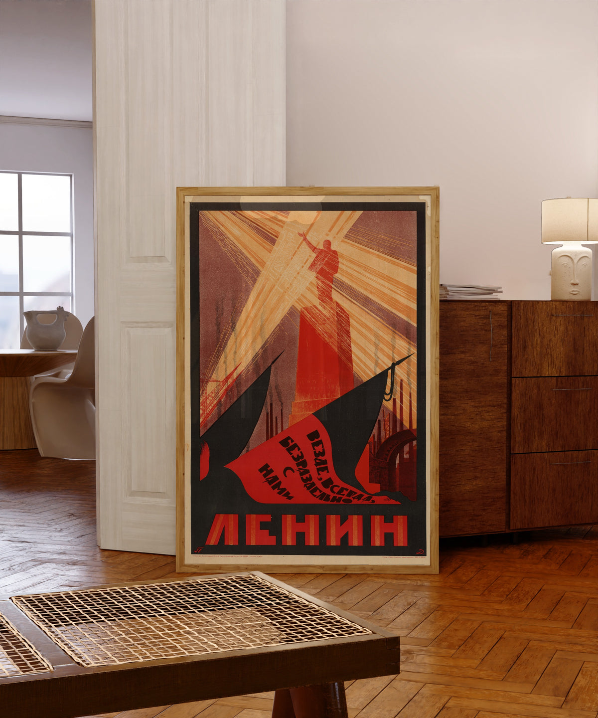 Framed art print of Everywhere, always, inseparably with us is Lenin, in a light wood frame leaning in a warm room with a parquet floor