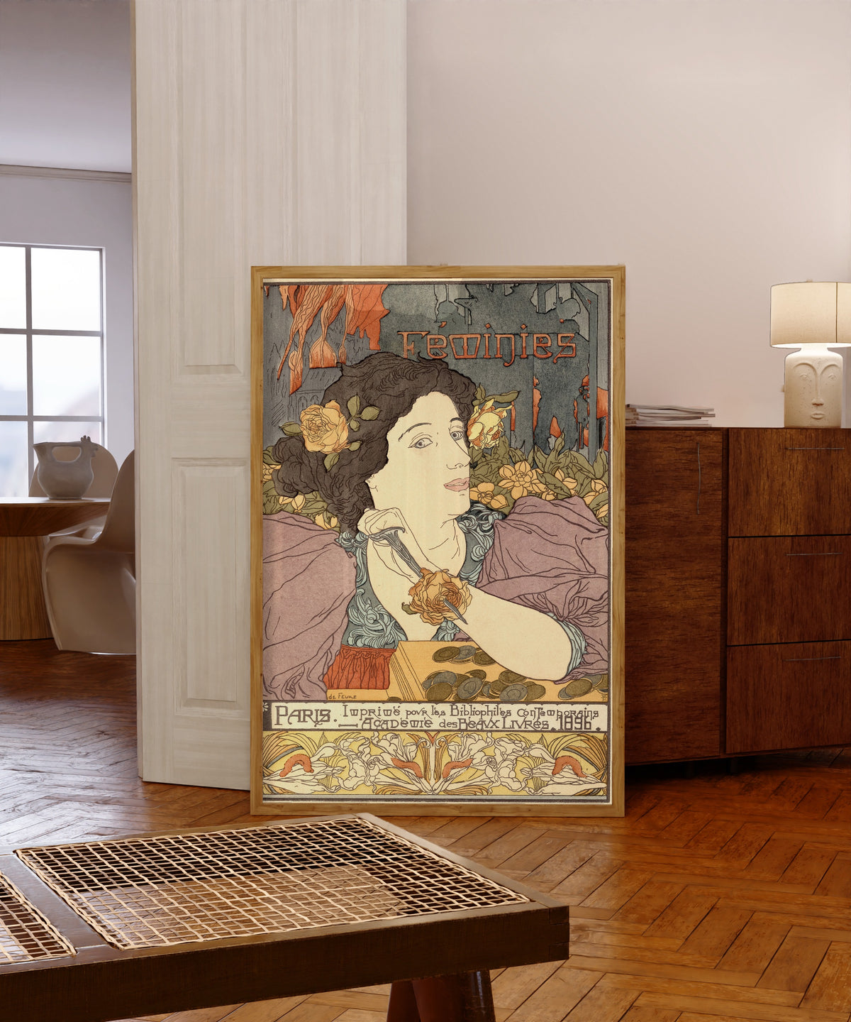 Framed art print of Féminies (frontispiece) by Georges de Feure, in a light wood frame leaning in a warm room with a parquet floor