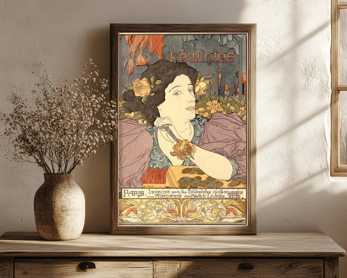 Framed art print of Féminies (frontispiece) by Georges de Feure, in a dark wood frame leaning on a rustic console beside dried flowers