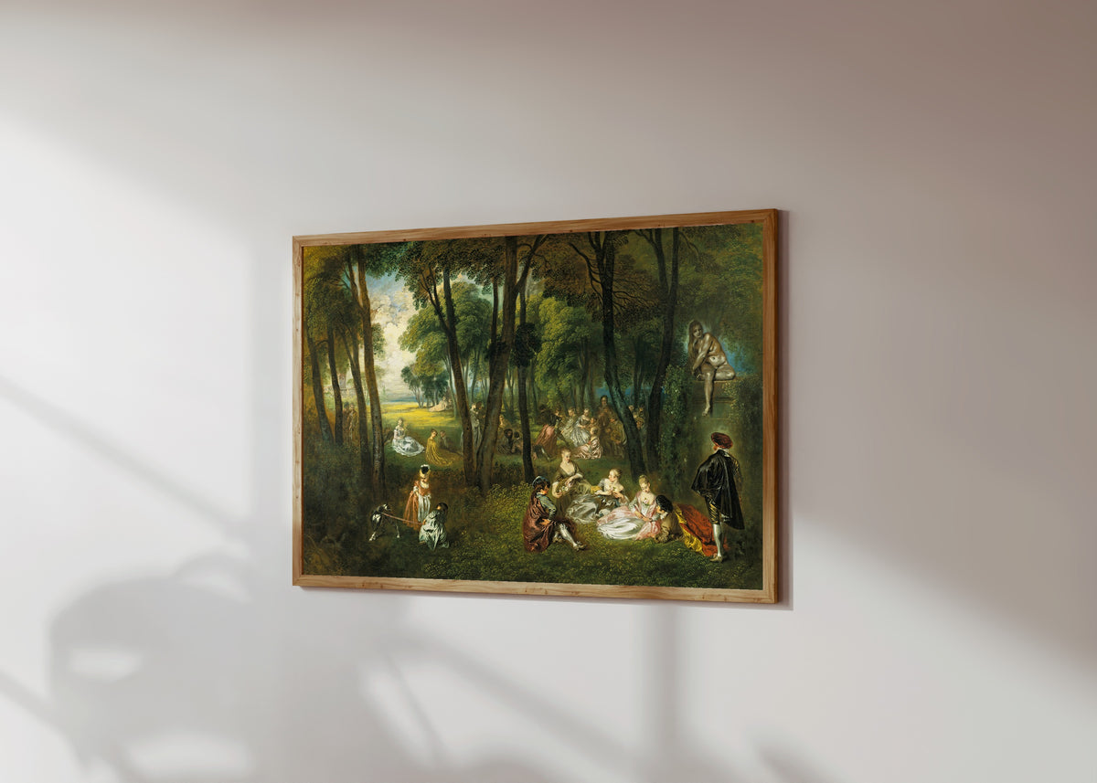 Framed art print of Fête galante in a Wooded Landscape by Jean-Antoine Watteau, in a light wood frame on a sunlit white wall, seen at a slight angle