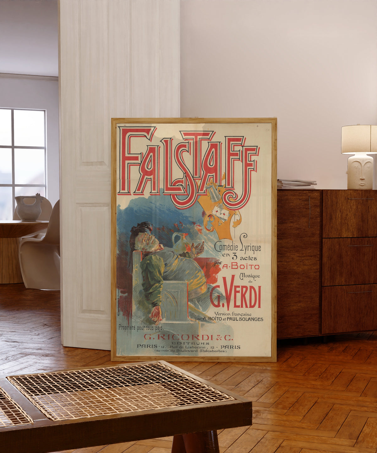 Framed art print of Falstaff: Comédie lyrique en 3 actes by Adolfo Hohenstein, in a light wood frame leaning in a warm room with a parquet floor