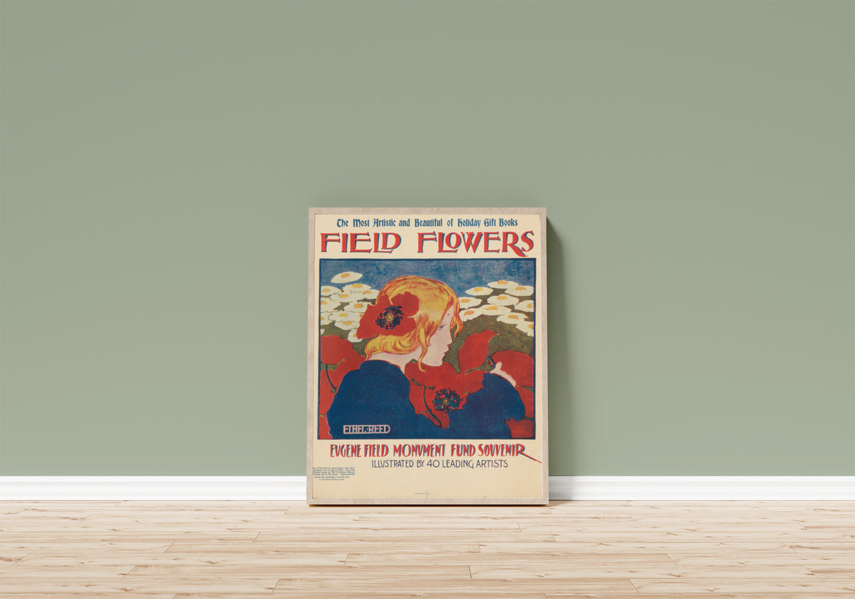Framed art print of Field Flowers: The Most Artistic and Beautiful of… by Ethel Reed, in a light wood frame leaning on a sage green wall above a wooden floor