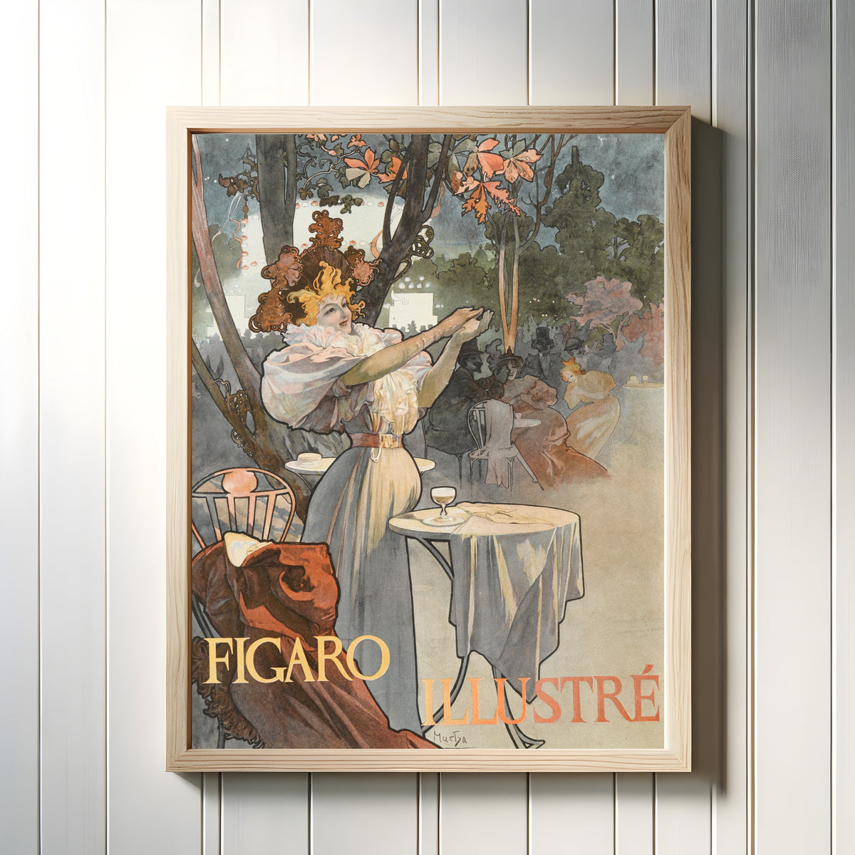 Framed art print of Figaro Illustré by Alphonse Mucha, in a light wood frame on a white panelled wall