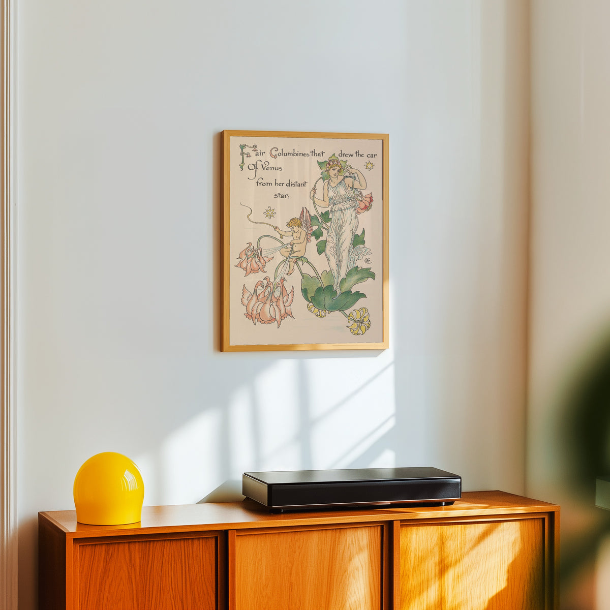 Framed art print of Flora's Feast: Columbines by Walter Crane, in a light wood frame on a white wall above an orange sideboard