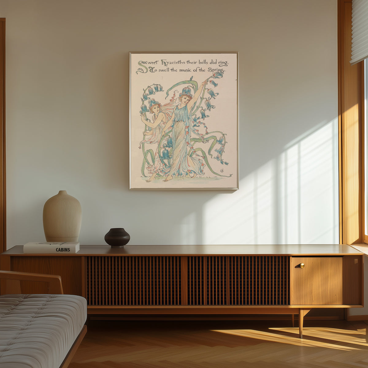 Framed art print of Flora's Feast: Hyacinths by Walter Crane, in a thin light frame on a sunlit wall above a wooden sideboard