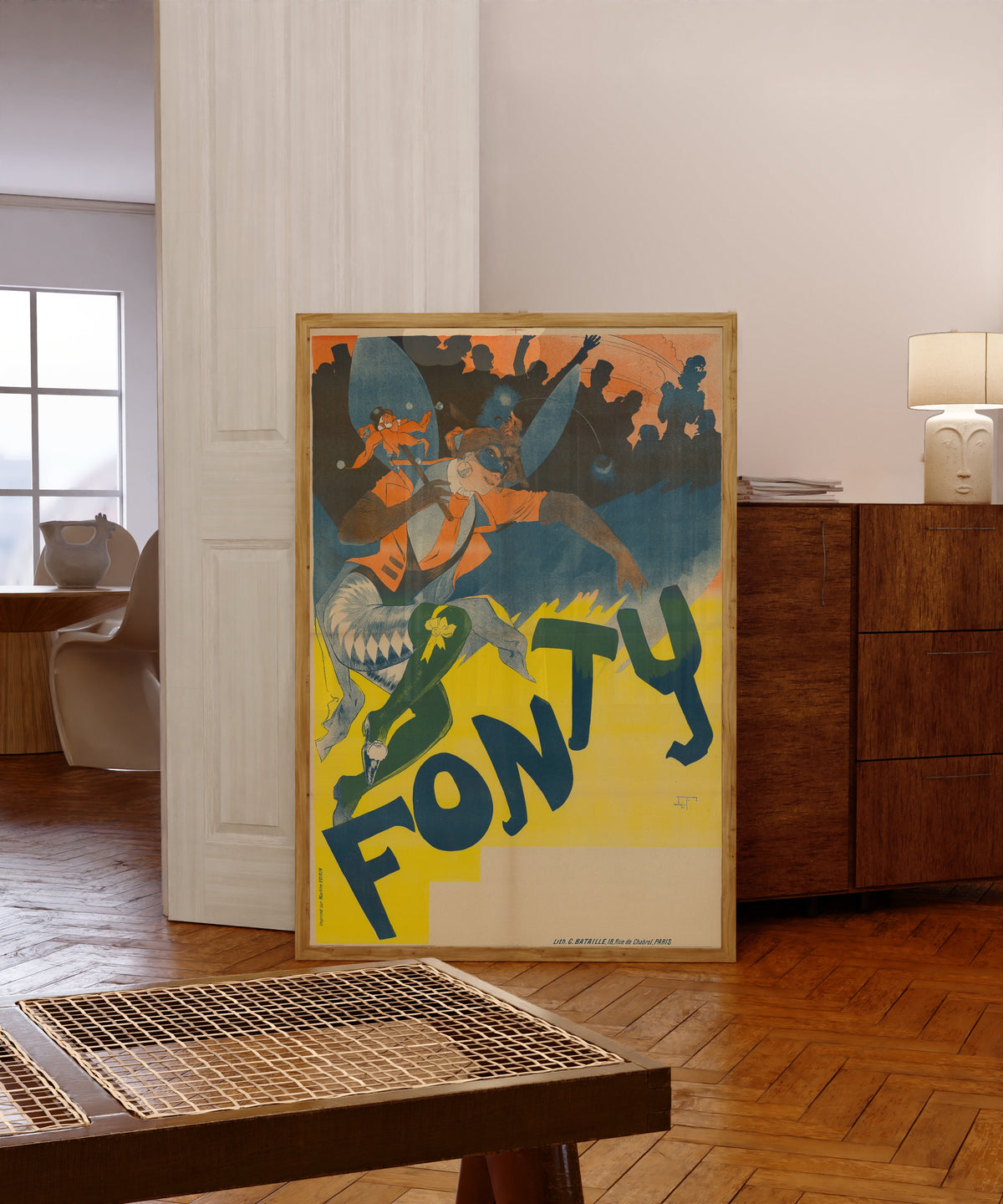 Framed art print of Fonty by Georges de Feure, in a light wood frame leaning in a warm room with a parquet floor