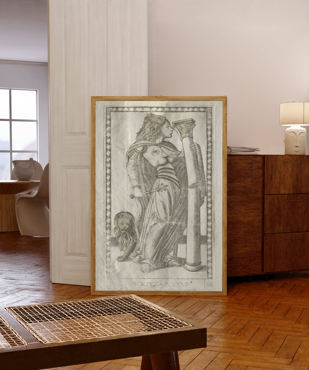 Framed art print of Forteza (from the Tarocchi, Series… by Master of the E-Series Tarocchi, in a light wood frame leaning in a warm room with a parquet floor