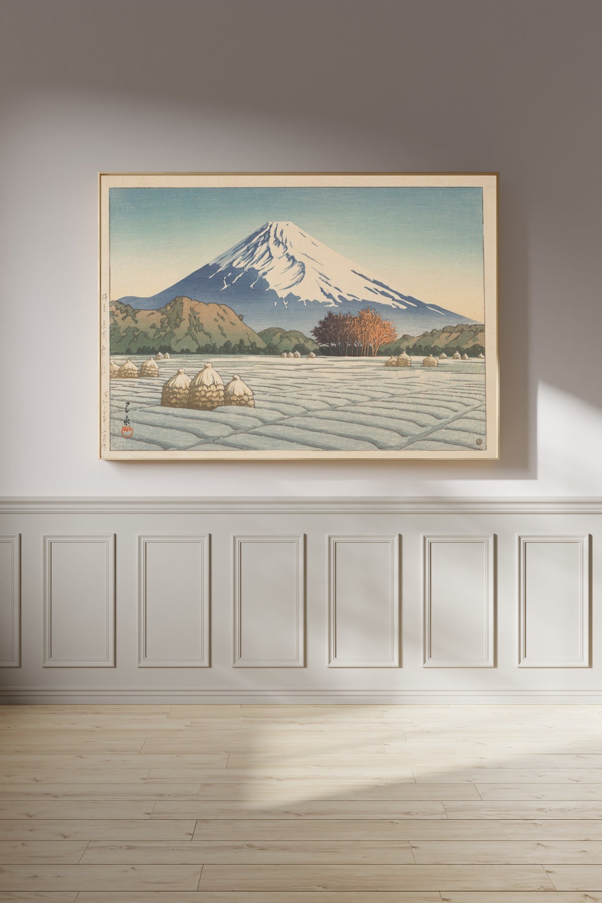 Framed art print of Frosty Morning in Nagaoka, Izu by Kawase Hasui, on a panelled wall in afternoon light