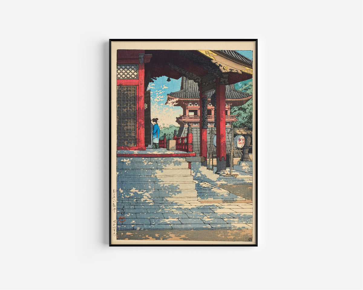 Framed art print of Fudo Hall in Meguro by Kawase Hasui, in a slim black frame on a plain white wall