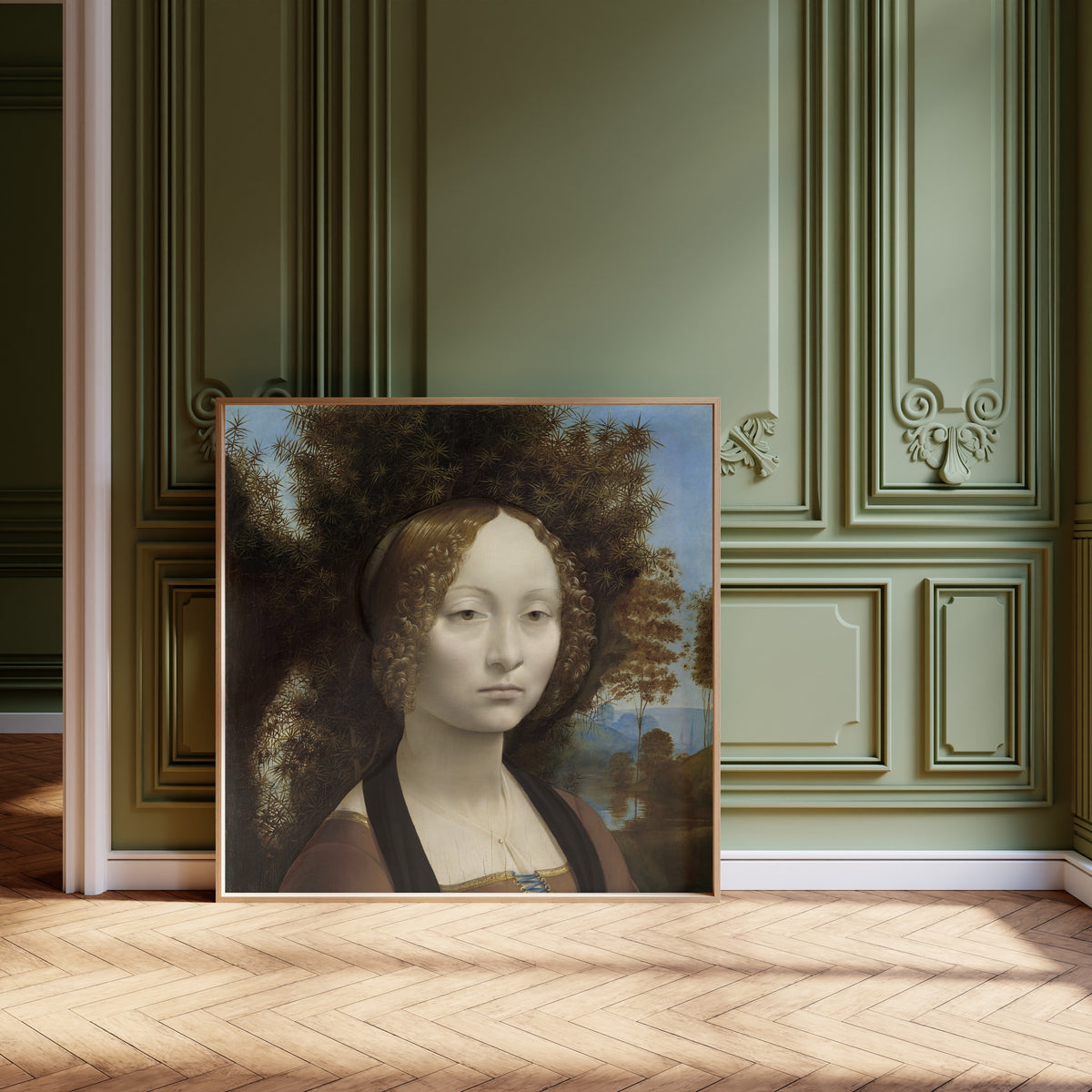 Framed art print of Ginevra de’ Benci by Leonardo da Vinci, leaning against olive-green panelling on a herringbone floor