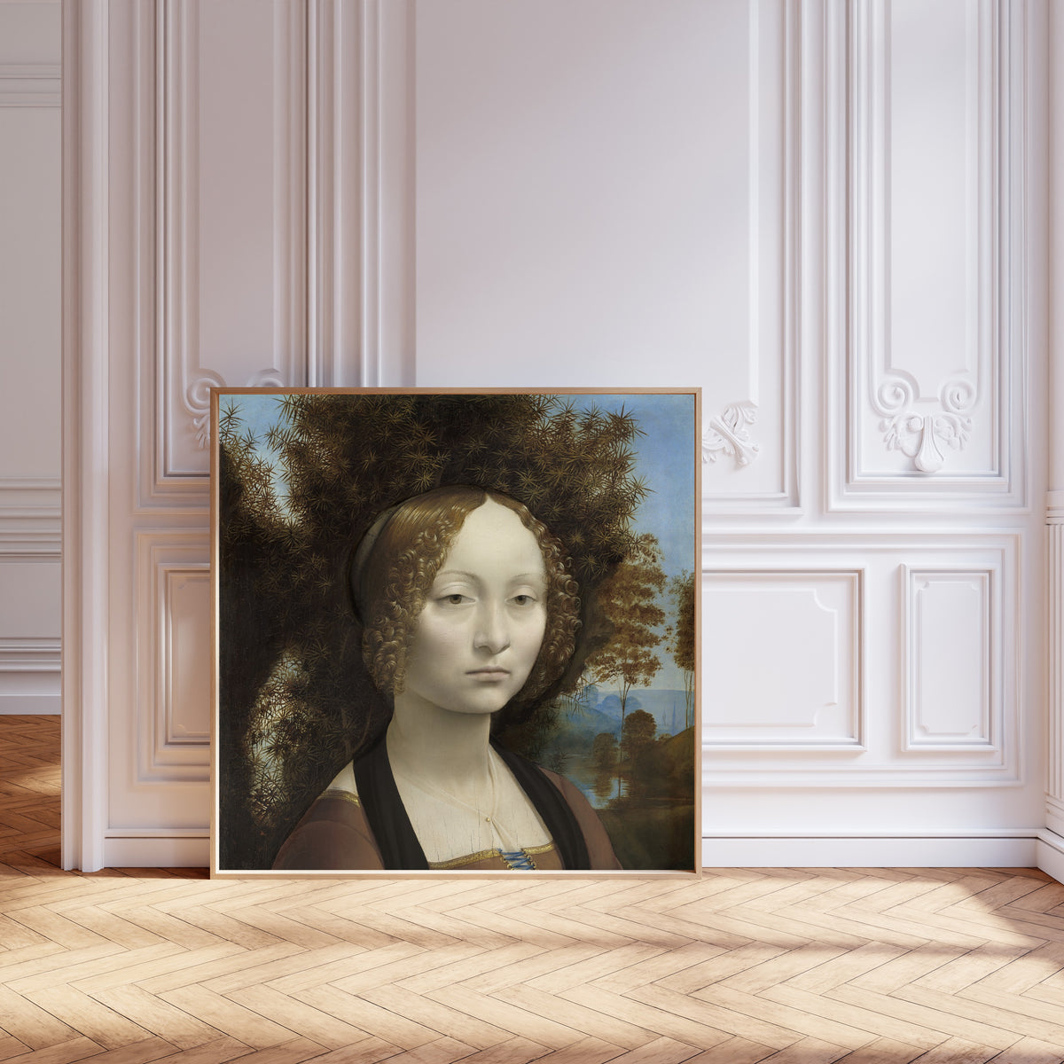 Framed art print of Ginevra de’ Benci by Leonardo da Vinci, leaning against pale pink panelling on a herringbone floor