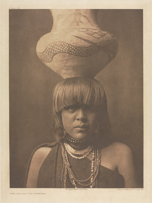 Girl and Jar, San Ildefonso by Edward S. Curtis — A San Ildefonso girl balances a serpent-painted jar on her head