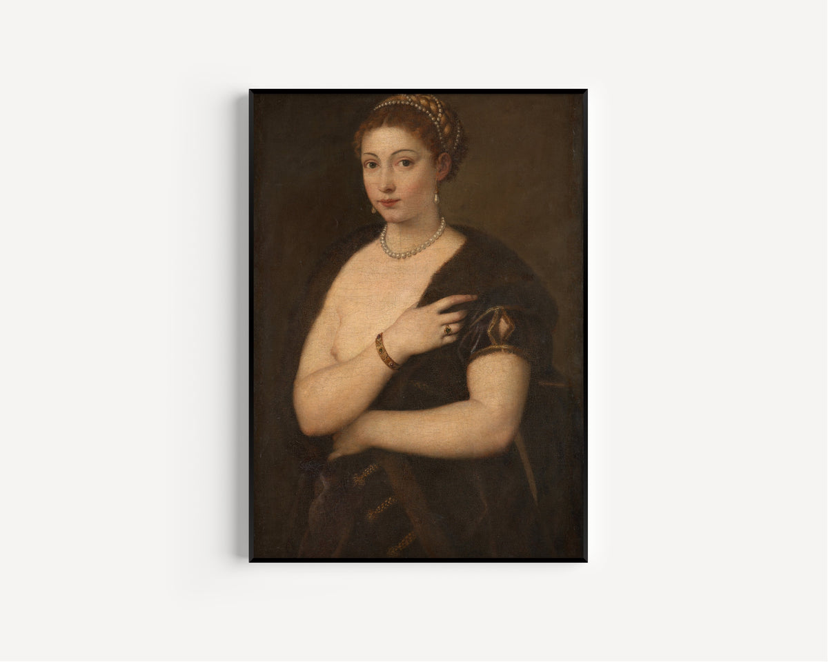 Framed art print of Girl in a Fur by Titian, in a slim black frame on a plain white wall