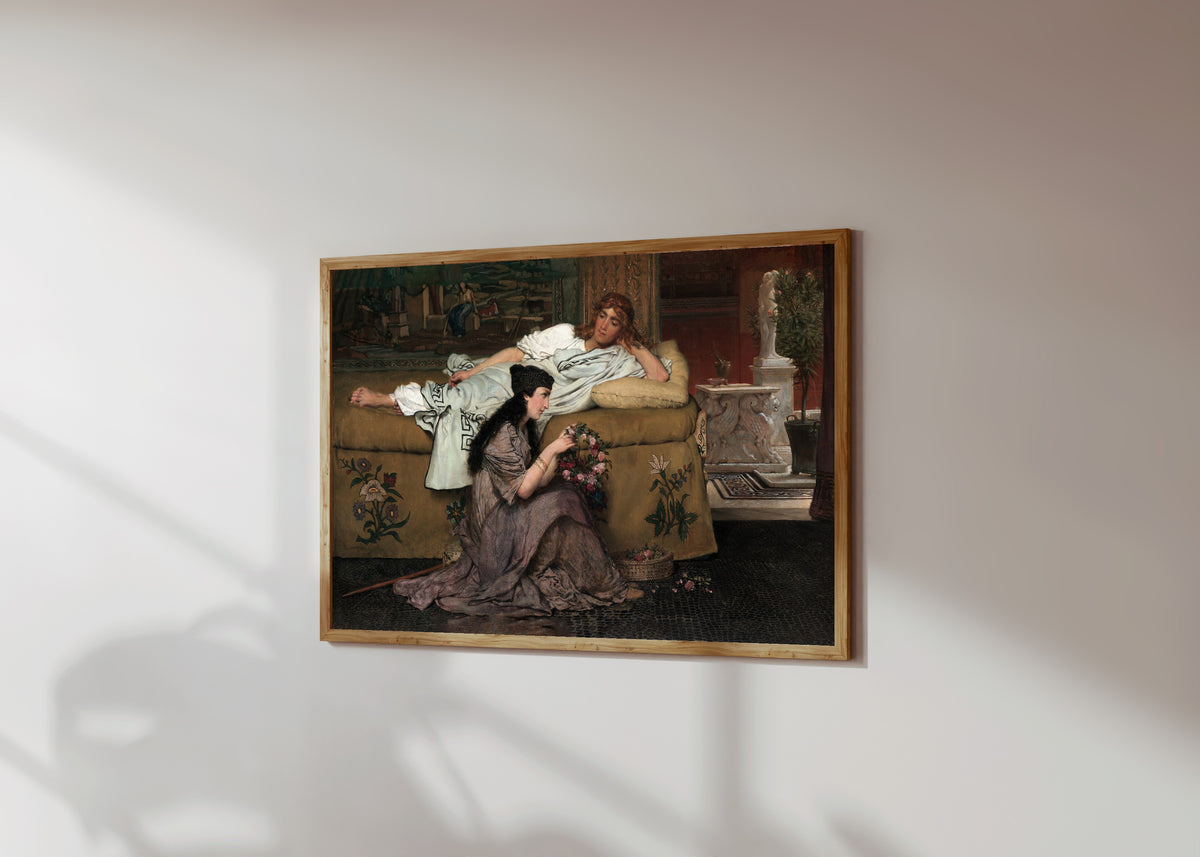 Framed art print of Glaucus and Nydia by Lawrence Alma-Tadema, in a light wood frame on a sunlit white wall, seen at a slight angle