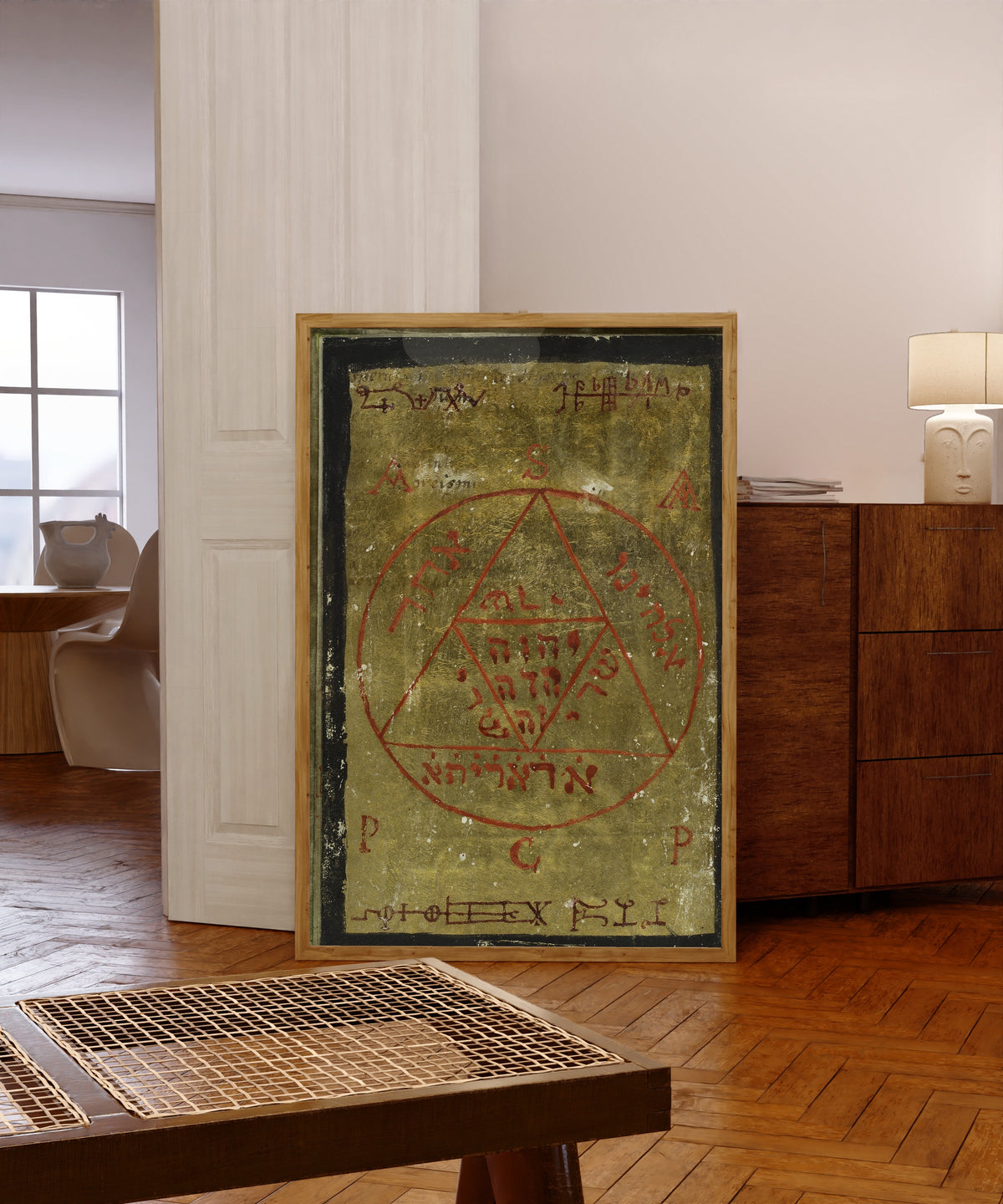 Framed art print of Gold Seal, from Cyprianus by Unknown artist, in a light wood frame leaning in a warm room with a parquet floor