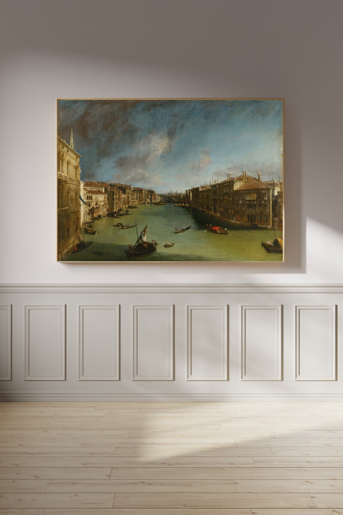 Framed art print of Grand Canal from Palazzo Balbi towards the Rialto by Canaletto, on a panelled wall in afternoon light
