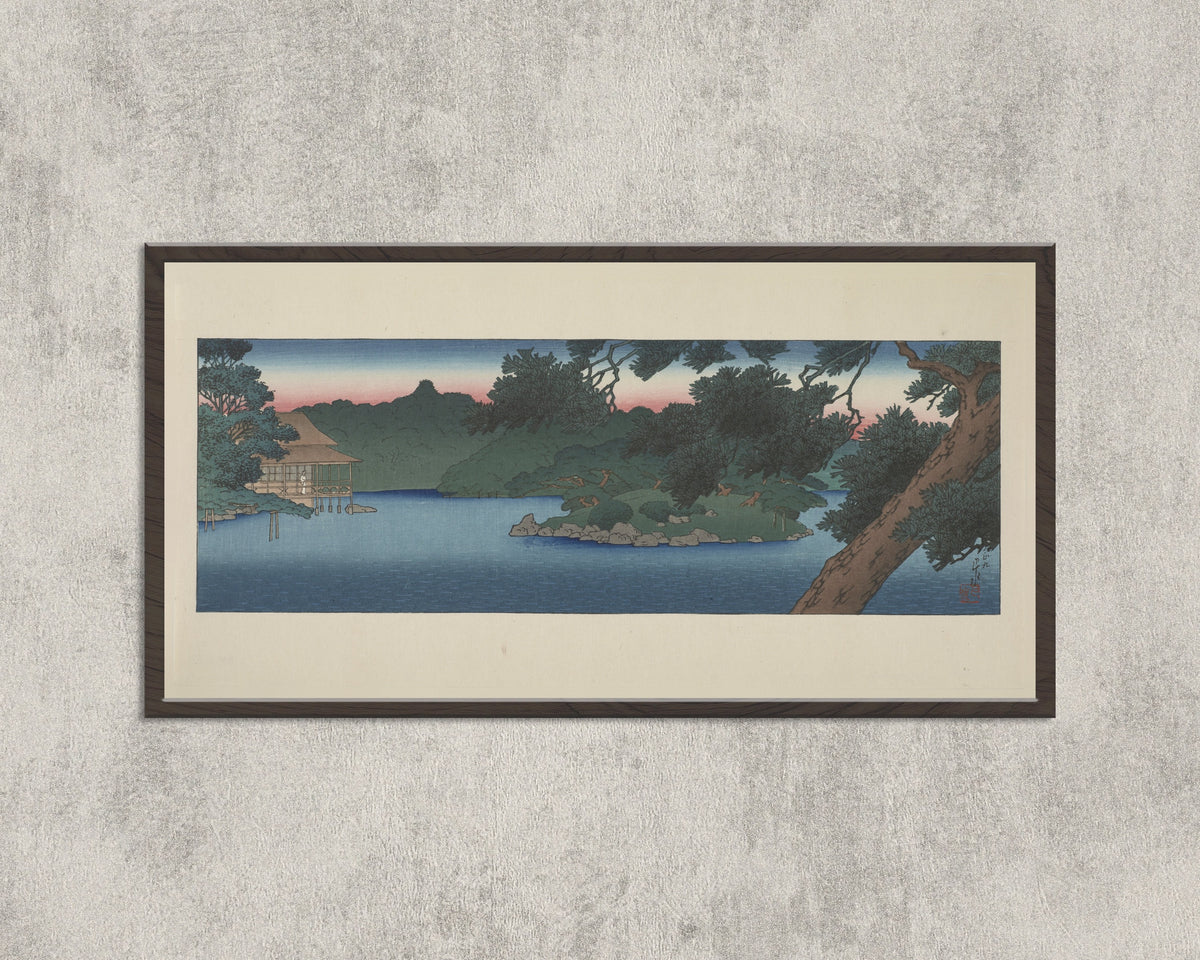 Framed art print of Guest House in the Pines, Mitsubishi Villa at Fukagawa by Kawase Hasui, in a wide black frame on a concrete wall