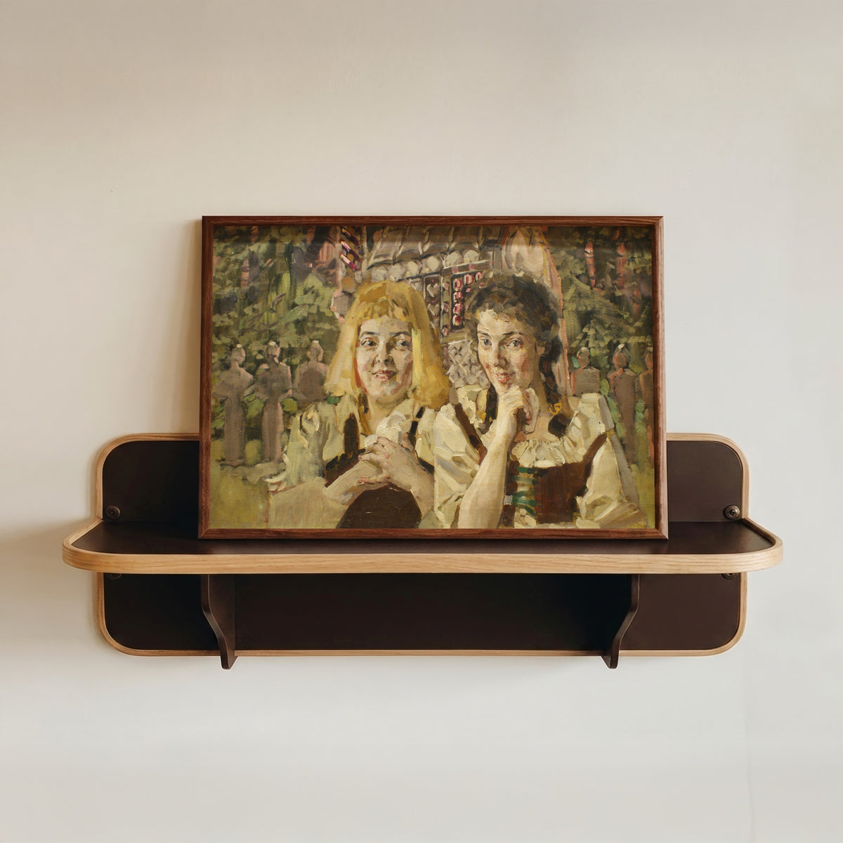 Framed art print of Hansel and Gretel by Mikhail Vrubel, in a dark wood frame resting on a wall shelf