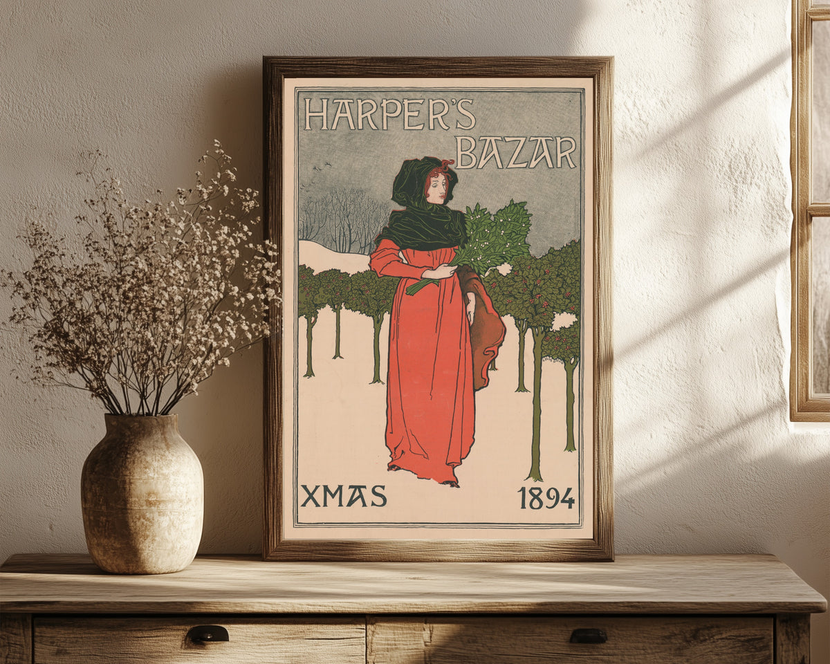 Framed art print of Harper's Bazar, Xmas 1894 by Louis Rhead, in a dark wood frame leaning on a rustic console beside dried flowers