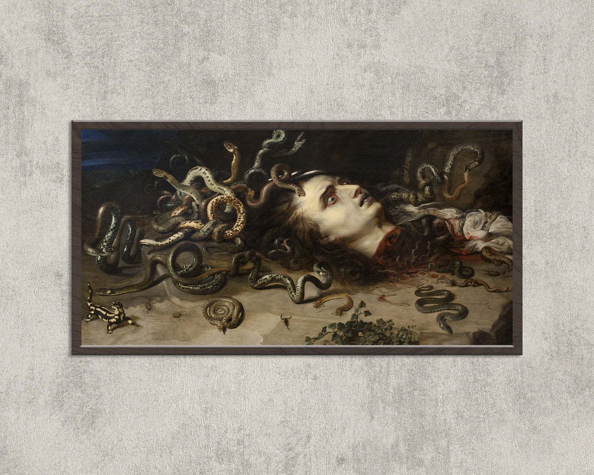 Framed art print of Head of Medusa by Peter Paul Rubens, in a wide black frame on a concrete wall