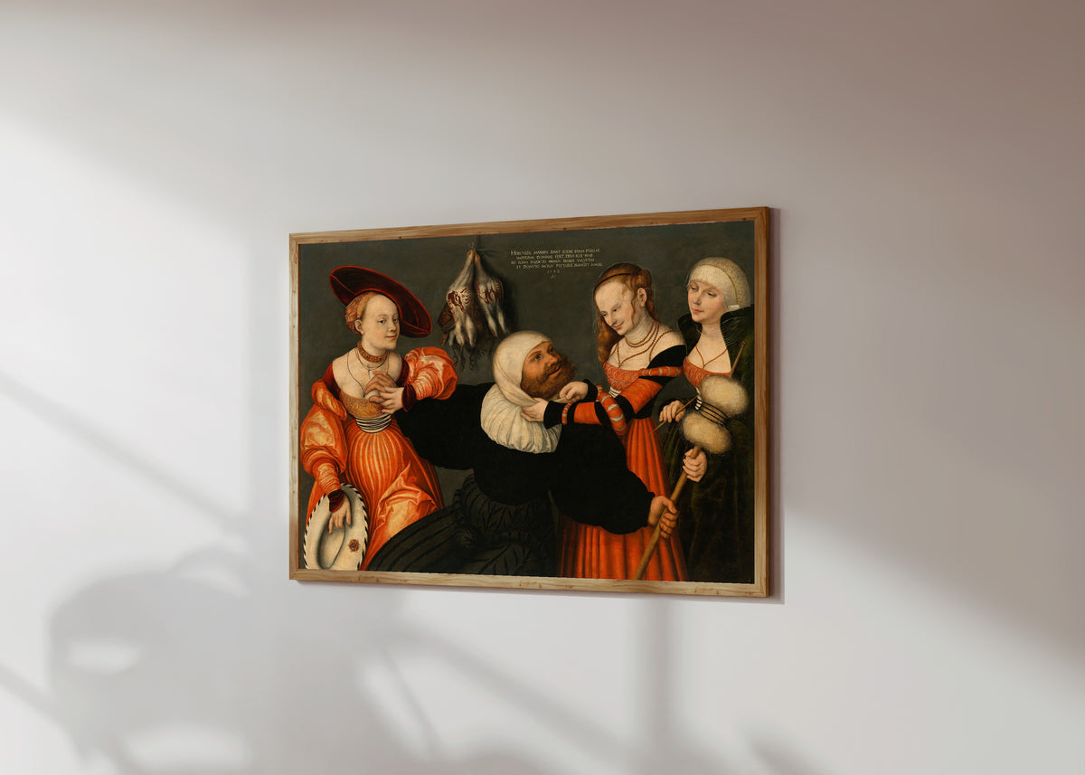 Framed art print of Hercules and Omphale by Lucas Cranach the Elder, in a light wood frame on a sunlit white wall, seen at a slight angle