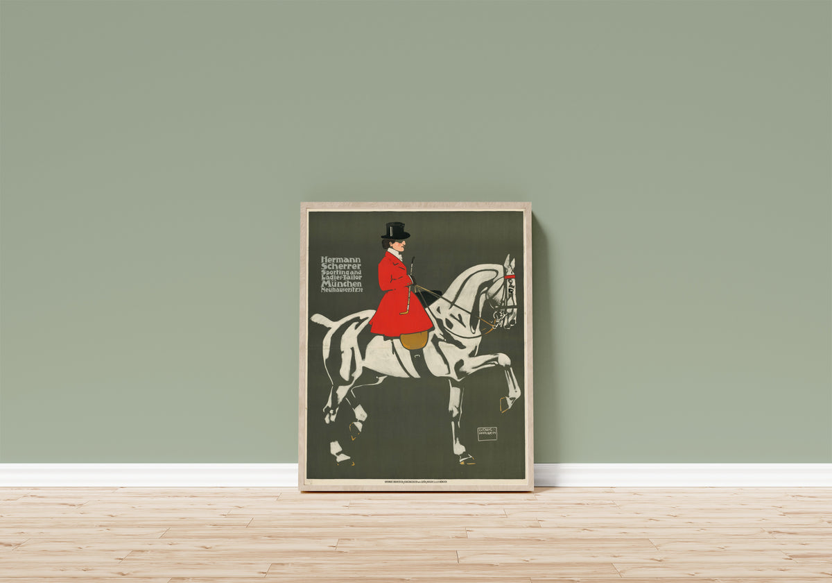 Framed art print of Hermann Scherrer: Sporting and Ladies-Tailor… by Ludwig Hohlwein, in a light wood frame leaning on a sage green wall above a wooden floor