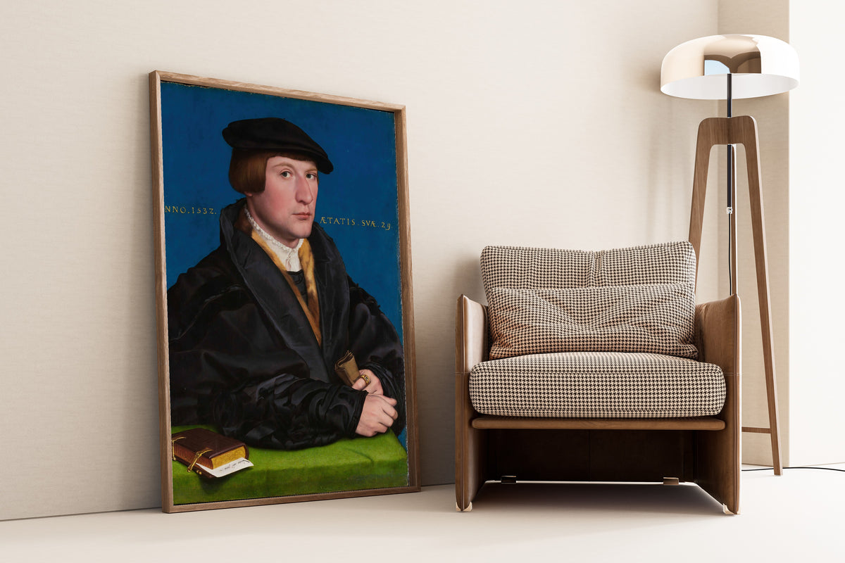 Framed art print of Hermann von Wedigh III by Hans Holbein the Younger, leaning against a wall beside an armchair and a floor lamp