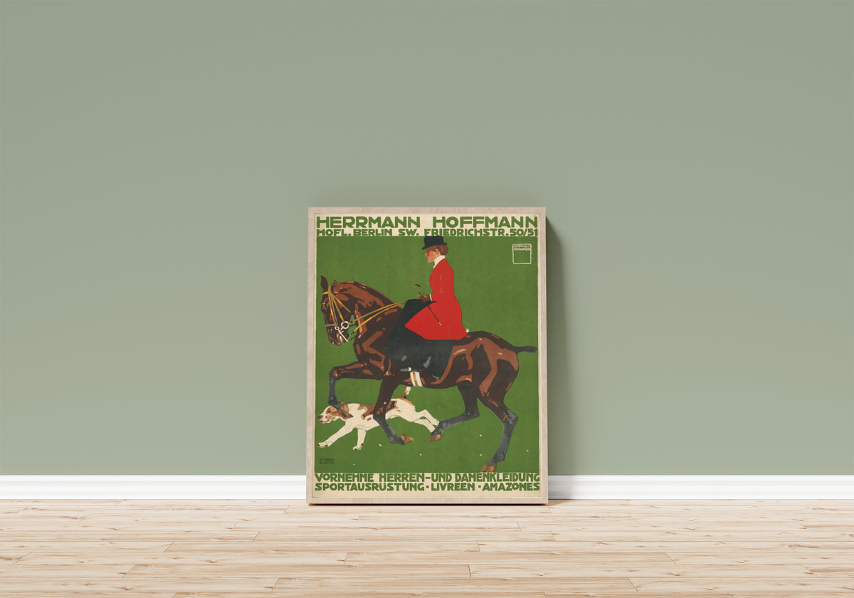 Framed art print of Herrmann Hoffmann: Vornehme Herren- und… by Ludwig Hohlwein, in a light wood frame leaning on a sage green wall above a wooden floor