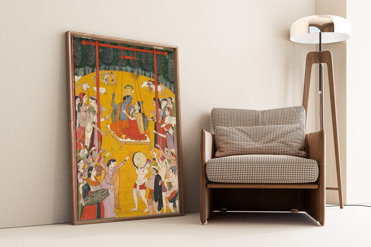 Framed art print of Hindola Raga by Pahari school, leaning against a wall beside an armchair and a floor lamp