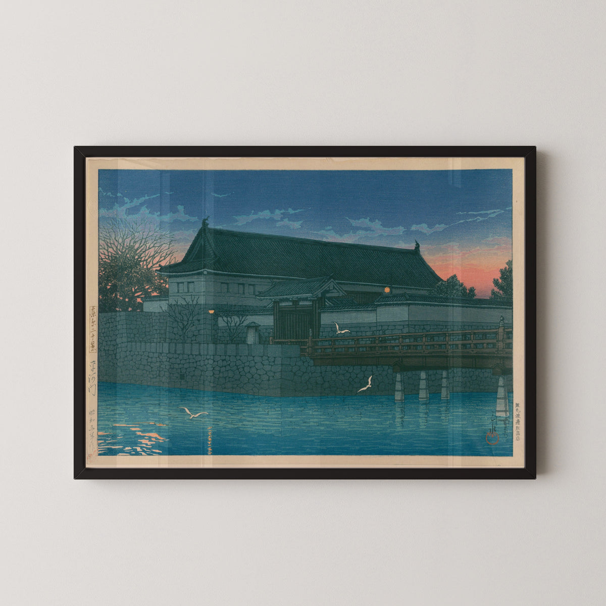 Framed art print of Hirakawa Gate by Kawase Hasui, in a black frame on a pale wall
