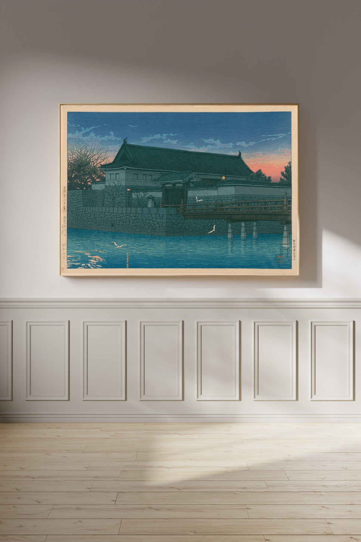 Framed art print of Hirakawa Gate by Kawase Hasui, on a panelled wall in afternoon light