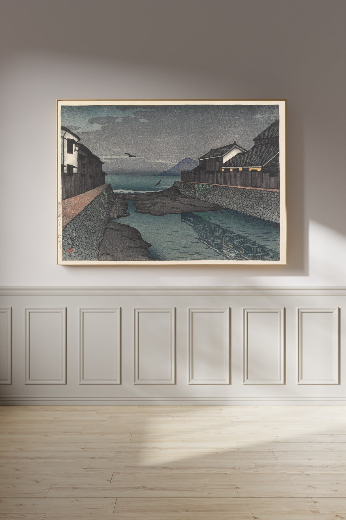 Framed art print of Hori River, Obama by Kawase Hasui, on a panelled wall in afternoon light