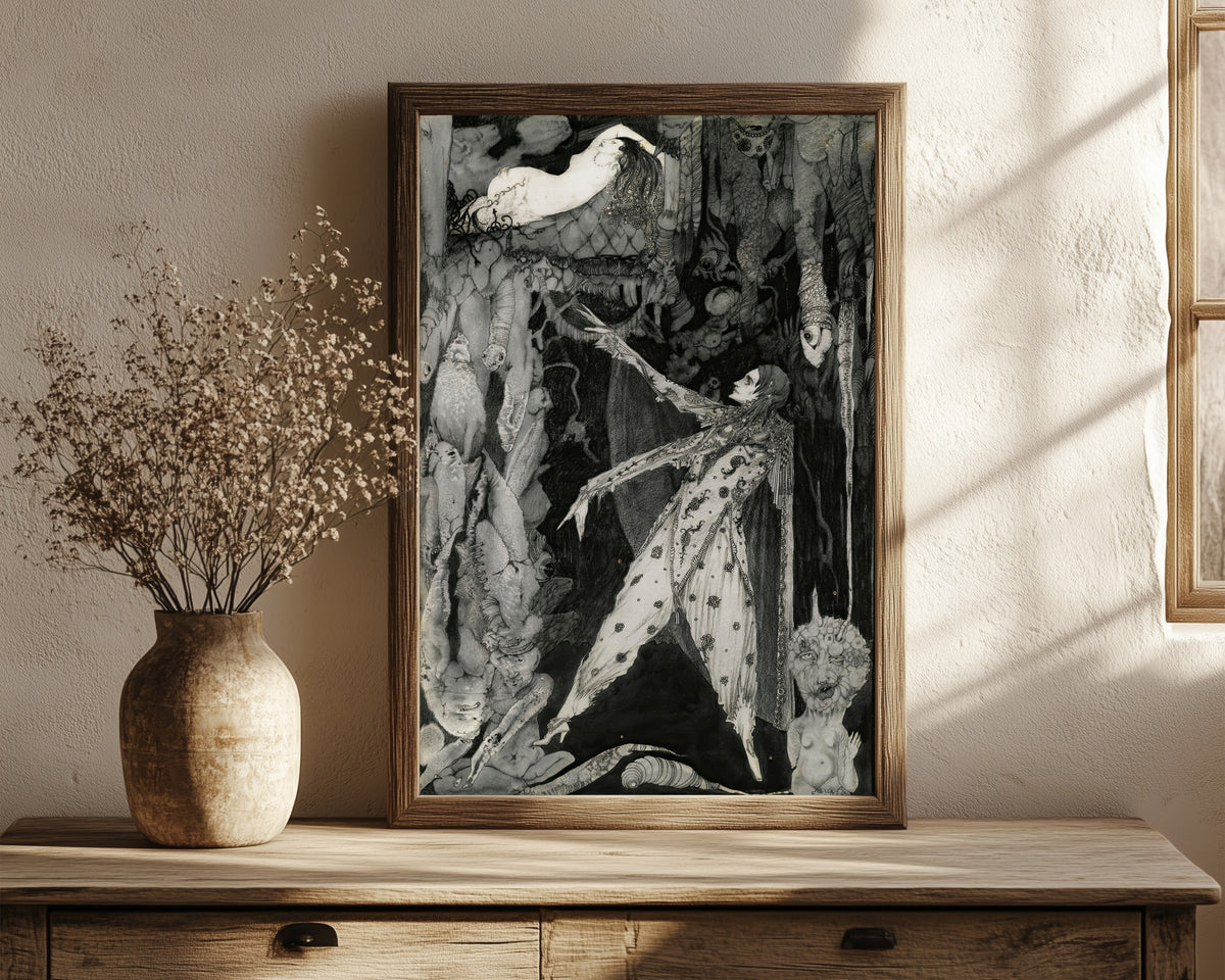 Framed art print of How Heavenly Fair by Harry Clarke, in a dark wood frame leaning on a rustic console beside dried flowers