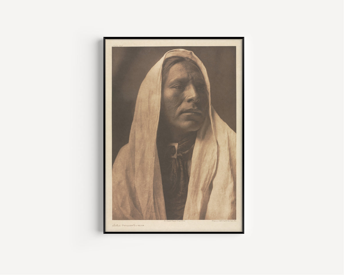 Framed art print of Iahla (Willow), Taos by Edward S. Curtis, in a slim black frame on a plain white wall