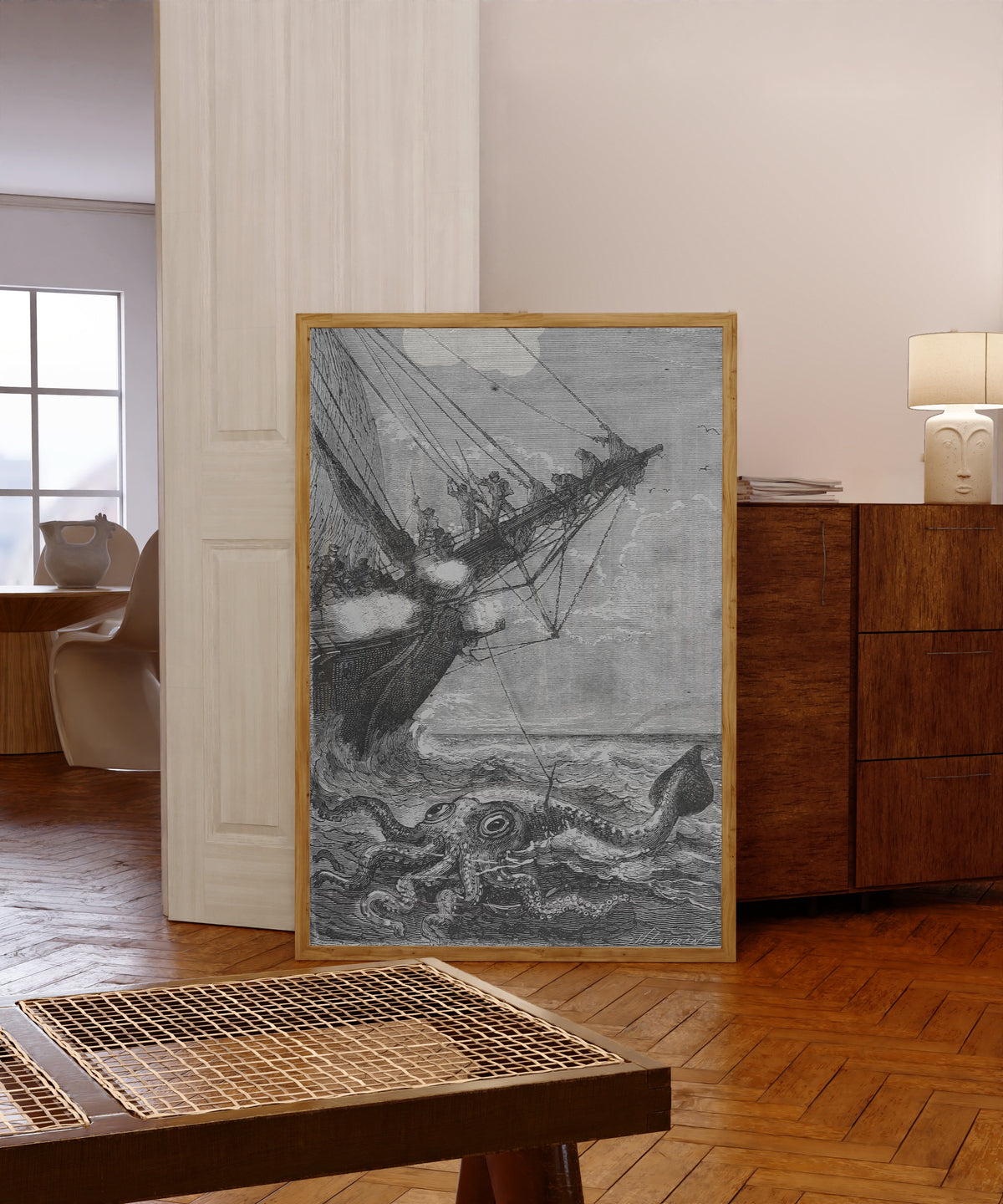 Framed art print of Il l'attaqua à coups de harpon (He attacked it… by Alphonse de Neuville, in a light wood frame leaning in a warm room with a parquet floor