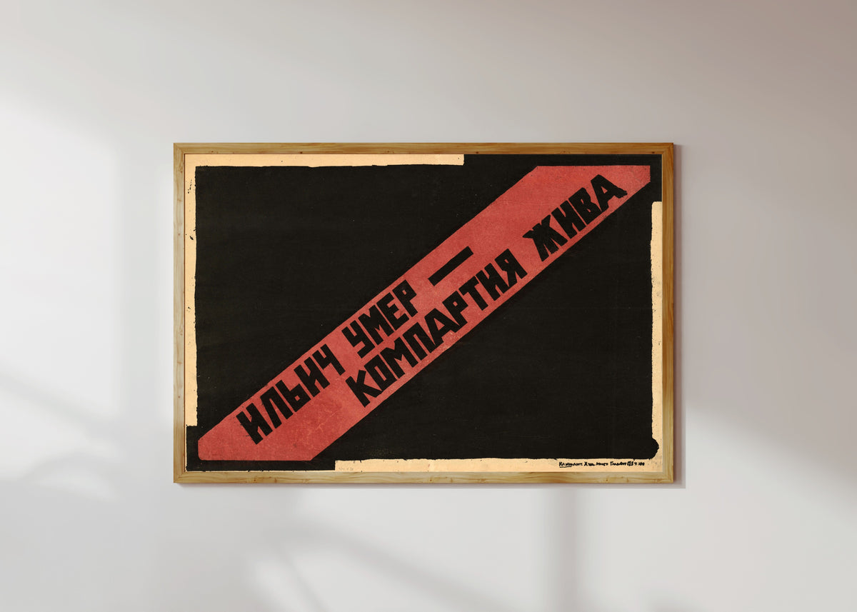 Framed art print of Ilyich is dead, the Communist Party lives, in a light wood frame on a sunlit white wall