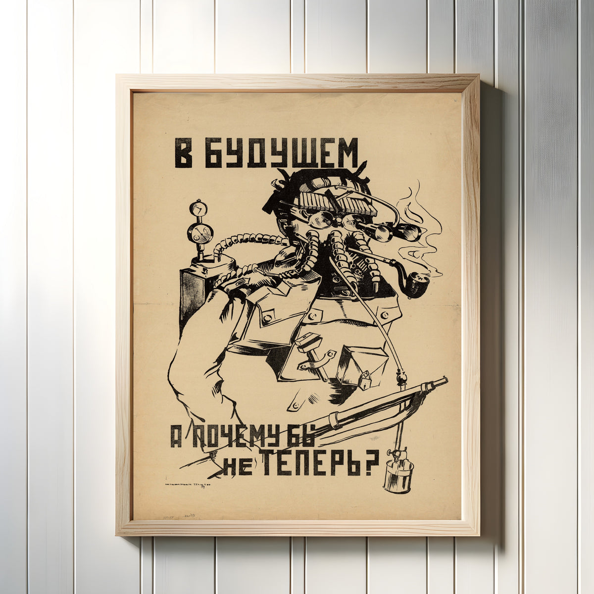 Framed art print of In the future... Why not now?, in a light wood frame on a white panelled wall