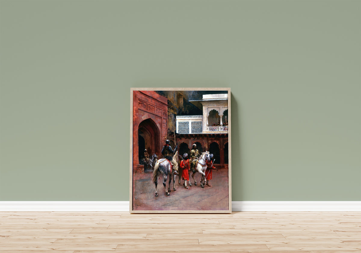 Framed art print of Indian Prince, Palace of Agra by Edwin Lord Weeks, in a light wood frame leaning on a sage green wall above a wooden floor