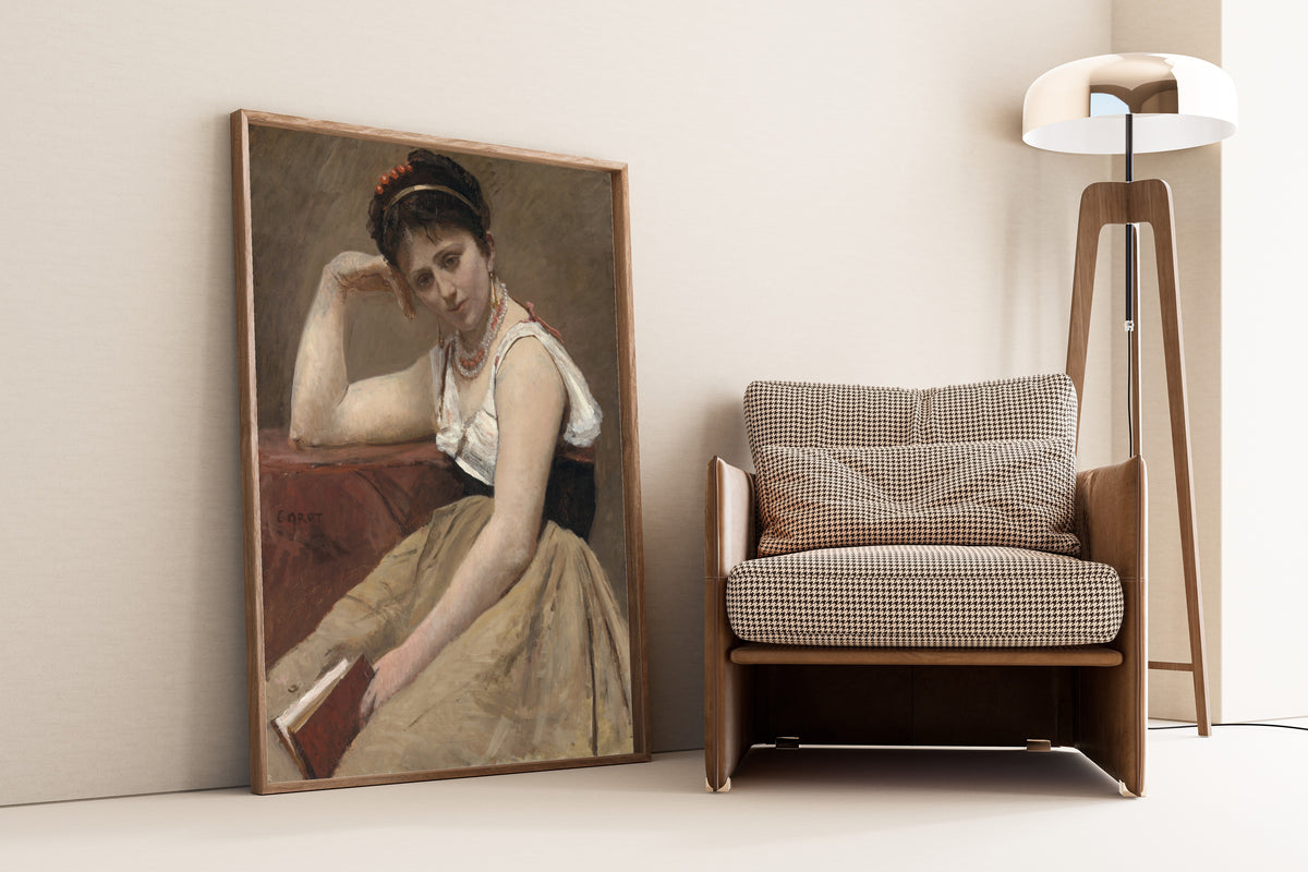 Interrupted Reading by Jean-Baptiste-Camille Corot — framed and leaning against a wall beside an armchair and a floor lamp