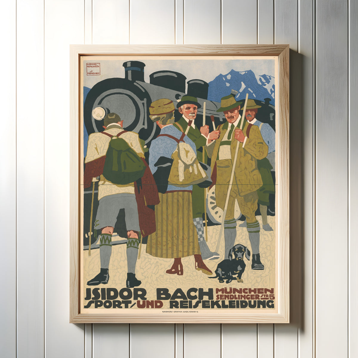 Framed art print of Isidor Bach: Sport- und Reisekleidung, München by Ludwig Hohlwein, in a light wood frame on a white panelled wall