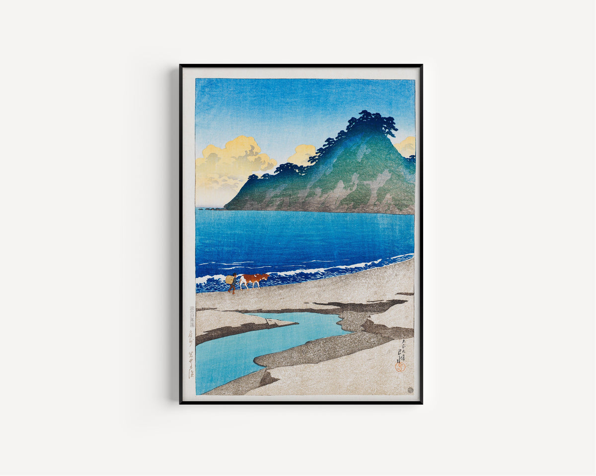 Framed art print of Iwai Beach, Awa Province by Kawase Hasui, in a slim black frame on a plain white wall