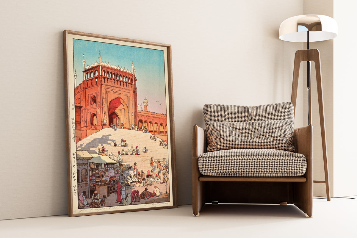 Framed art print of Jama Masjid, Delhi by Hiroshi Yoshida, leaning against a wall beside an armchair and a floor lamp