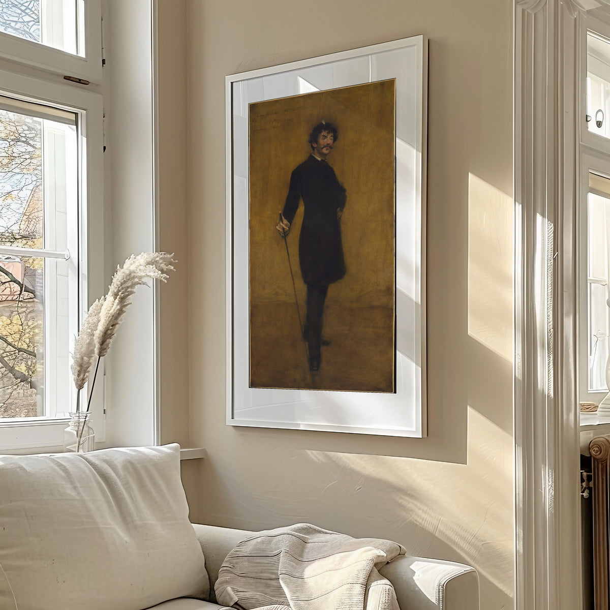 James Abbott McNeill Whistler by William Merritt Chase — framed in a sunlit living room above a sofa