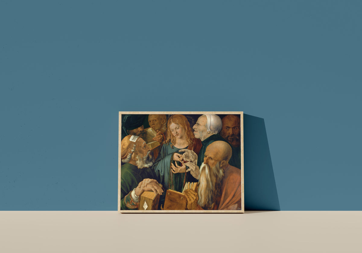 Framed art print of Jesus Among the Doctors by Albrecht Dürer, in a light wood frame leaning on a blue wall