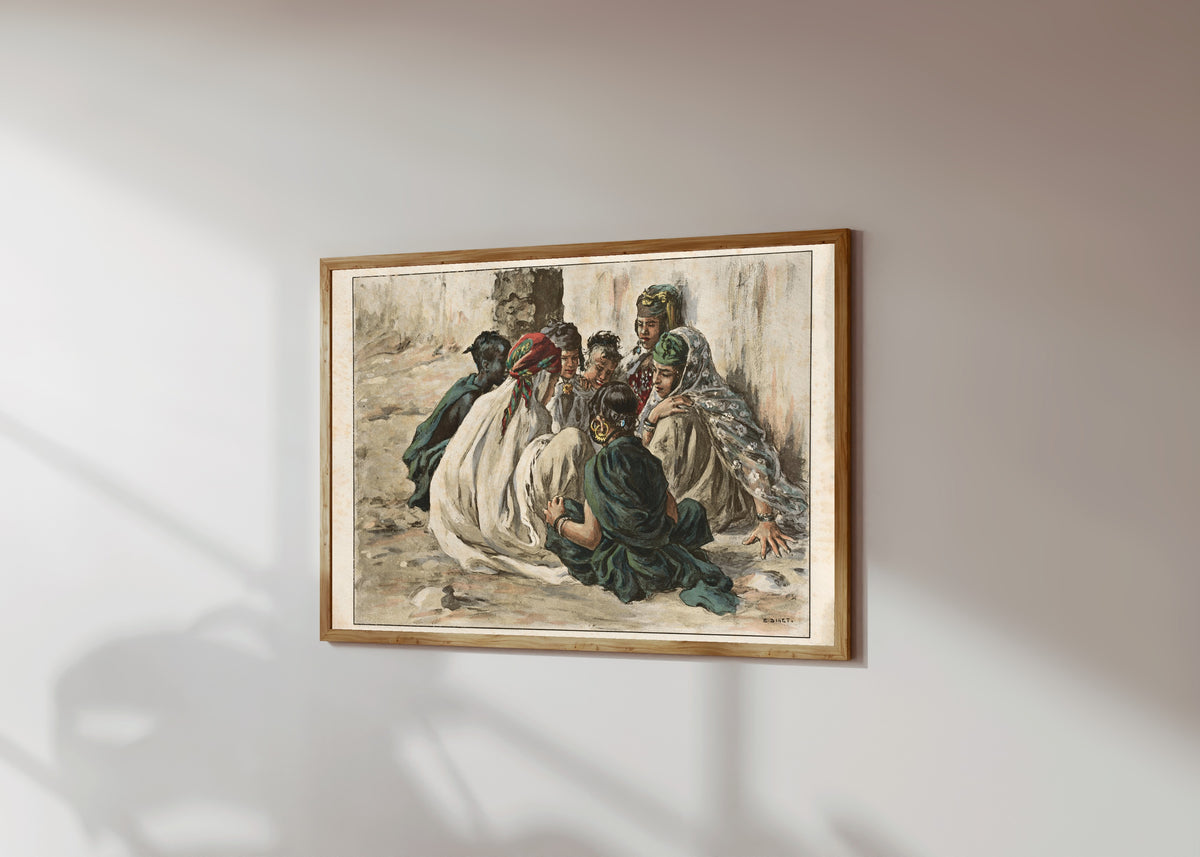 Framed art print of Jeux de fillettes à Laghouat by Étienne Dinet, in a light wood frame on a sunlit white wall, seen at a slight angle