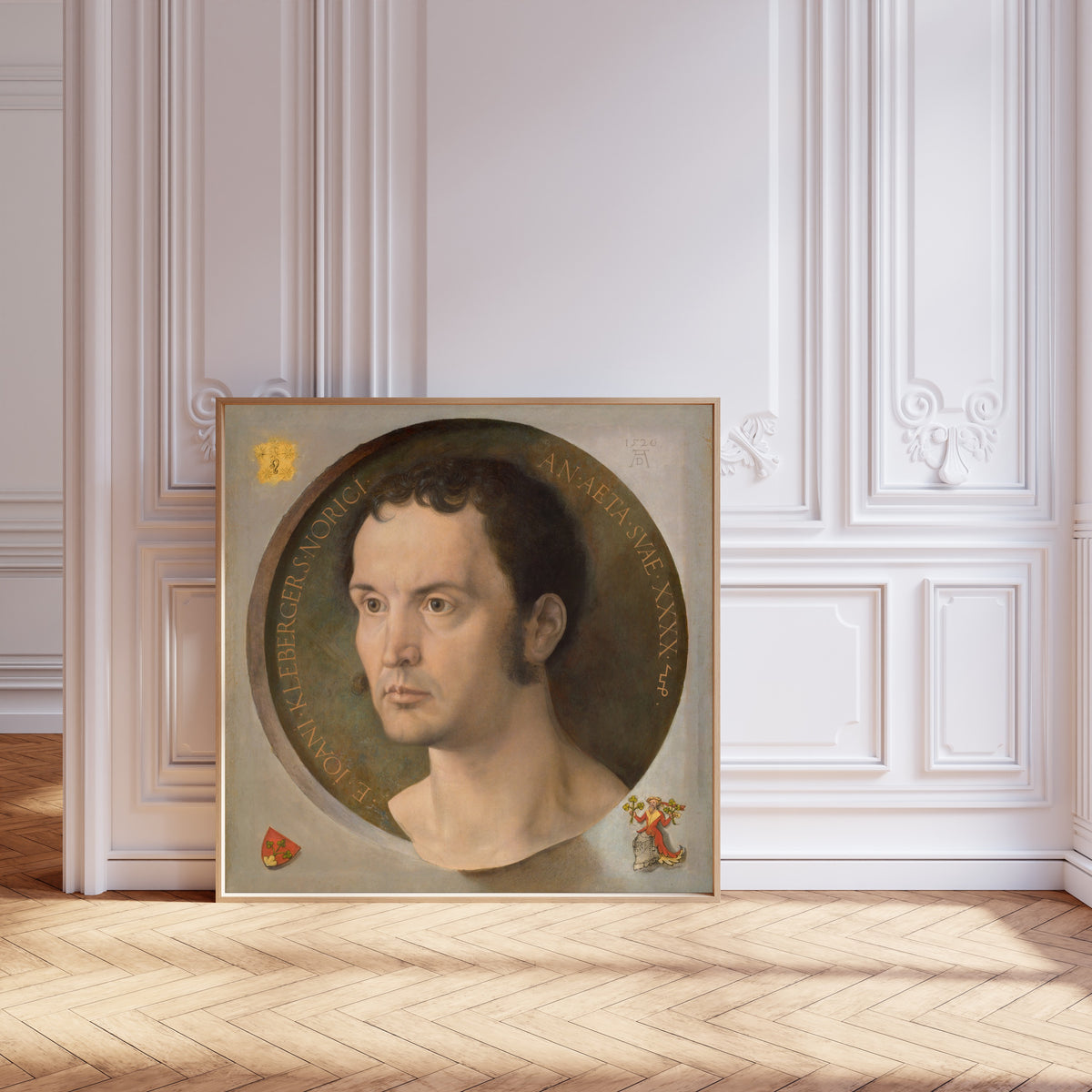 Framed art print of Johannes Kleberger by Albrecht Dürer, leaning against pale pink panelling on a herringbone floor