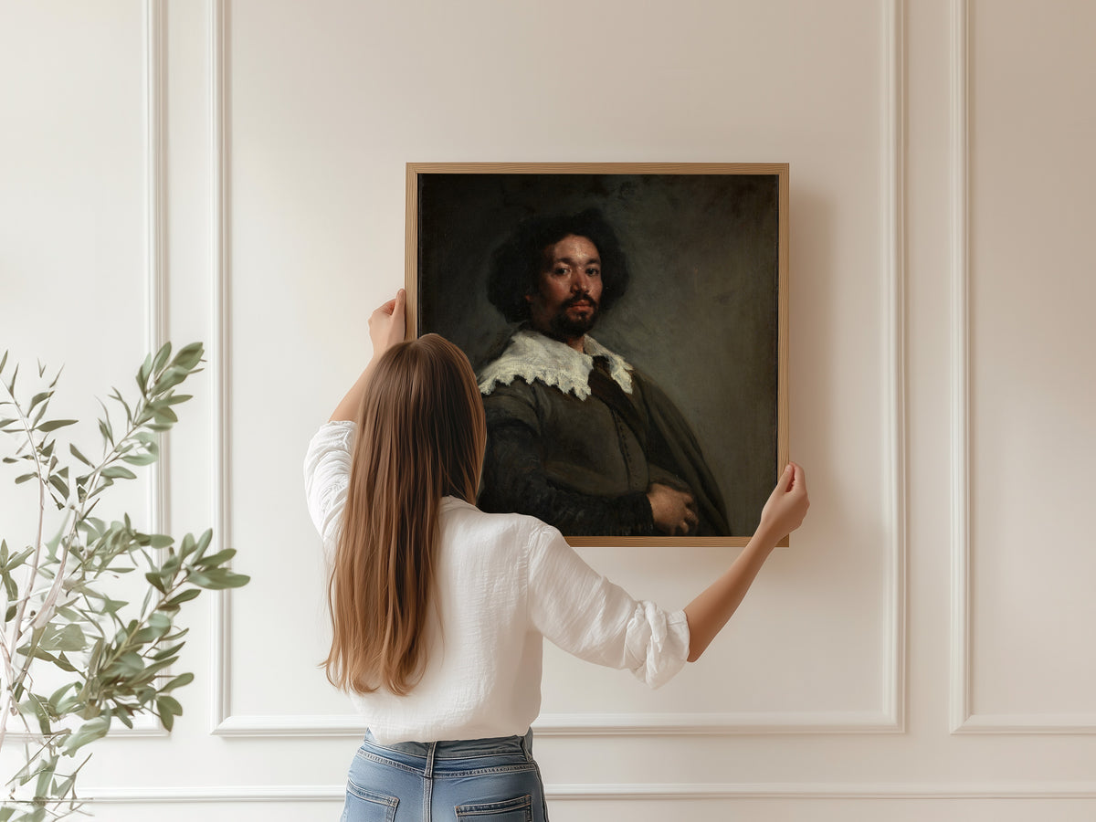 Framed art print of Juan de Pareja by Diego Velázquez, hung on a panelled wall